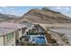 Stunning backyard with a sparkling pool, lush landscaping, and outdoor entertaining areas and mountain views at 3000 Raywood Ash Dr, Las Vegas, NV 89138
