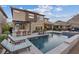 Inviting backyard features a refreshing pool, outdoor bar, and lounge seating, perfect for entertaining guests at 3000 Raywood Ash Dr, Las Vegas, NV 89138