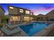 Inviting backyard with a private pool, outdoor kitchen, and comfortable seating areas at 3000 Raywood Ash Dr, Las Vegas, NV 89138