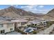 Aerial view of backyards with pools, patios, and mountain views, in a desert community at 3000 Raywood Ash Dr, Las Vegas, NV 89138