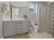 Well-lit bathroom featuring a gray vanity, white countertop, and patterned shower curtain at 3000 Raywood Ash Dr, Las Vegas, NV 89138