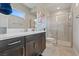 Modern bathroom boasts double vanity, sleek fixtures, and a glass-enclosed shower with subway tile at 3000 Raywood Ash Dr, Las Vegas, NV 89138