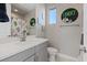 Charming bathroom with gray vanity, white countertop, and cactus-themed decor at 3000 Raywood Ash Dr, Las Vegas, NV 89138