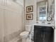 Cozy bathroom featuring a shower with curtain, toilet, and vanity with dark cabinets at 3000 Raywood Ash Dr, Las Vegas, NV 89138