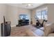 Relaxing bedroom with laminate flooring, ceiling fan, and a comfortable seating area at 3000 Raywood Ash Dr, Las Vegas, NV 89138