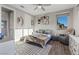 Comfortable bedroom featuring a ceiling fan, wood-look floors, and charming decor at 3000 Raywood Ash Dr, Las Vegas, NV 89138