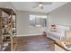 Bright bedroom with hardwood floors, white crib, and views of the mountains at 3000 Raywood Ash Dr, Las Vegas, NV 89138
