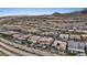 Aerial view of a residential area featuring well-maintained homes with mountain views and desert landscaping at 3000 Raywood Ash Dr, Las Vegas, NV 89138