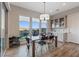 Dining area with backyard views, a modern chandelier, and a gray built-in hutch at 3000 Raywood Ash Dr, Las Vegas, NV 89138