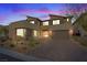 Modern two-story home showcases a sleek exterior with a three car garage and a well-manicured front yard at 3000 Raywood Ash Dr, Las Vegas, NV 89138