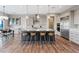 Spacious kitchen with gray cabinets, stainless appliances and large island with bar stool seating at 3000 Raywood Ash Dr, Las Vegas, NV 89138
