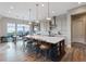 Open kitchen featuring a large island with seating and eat-in dining area with backyard views at 3000 Raywood Ash Dr, Las Vegas, NV 89138