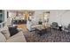 Open-concept living room showcases stylish furnishings and seamless flow to kitchen with bar stool seating at 3000 Raywood Ash Dr, Las Vegas, NV 89138