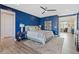 Main bedroom with decorative blue accent wall, carpet and walk-in closet at 3000 Raywood Ash Dr, Las Vegas, NV 89138
