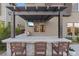 Stylish outdoor kitchen with bar seating, a built-in grill, and a covered pergola at 3000 Raywood Ash Dr, Las Vegas, NV 89138
