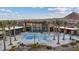 Exterior aerial view of a community pool surrounded by palm trees and lounge chairs, with a clubhouse at 3000 Raywood Ash Dr, Las Vegas, NV 89138