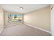 Bedroom with neutral walls, carpet flooring, and a large window at 3123 Key Largo Dr # 101, Las Vegas, NV 89120