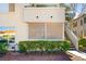 Exterior view of the building showing stairs to the upper units and well maintained landscaping at 3123 Key Largo Dr # 101, Las Vegas, NV 89120
