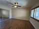 Comfortable bedroom featuring wood-style flooring, mirrored closet doors, and natural light at 340 Manti Pl # 0, Henderson, NV 89014