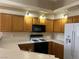 Functional kitchen featuring wood cabinets, sleek countertops, and modern appliances at 340 Manti Pl # 0, Henderson, NV 89014