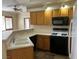 Functional kitchen featuring wood cabinets, sleek countertops, and modern appliances at 340 Manti Pl # 0, Henderson, NV 89014