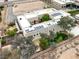 Overhead view of property showing greenery, solar panels on white roof, garden area, and three-car garage at 3910 W Pebble Rd, Las Vegas, NV 89139