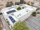 A high-angle view shows solar panels and air conditioning units on the roof of this residence with three-car garage at 3910 W Pebble Rd, Las Vegas, NV 89139