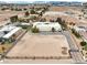 An aerial view highlights the expansive lot, desert surroundings, and three-car garage of the featured residence at 3910 W Pebble Rd, Las Vegas, NV 89139