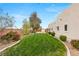 Lush green backyard with manicured lawn and landscaped garden beds at 3910 W Pebble Rd, Las Vegas, NV 89139