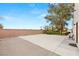 Asphalt basketball court area next to a lush grass area and exterior wall at 3910 W Pebble Rd, Las Vegas, NV 89139