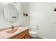 Bathroom with oak vanity, linoleum flooring and natural lighting at 3910 W Pebble Rd, Las Vegas, NV 89139