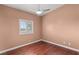 A minimalist bedroom featuring a ceiling fan and shuttered window at 3910 W Pebble Rd, Las Vegas, NV 89139