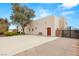 Beige home with a basketball hoop and bench, front door, and secured gate at 3910 W Pebble Rd, Las Vegas, NV 89139