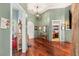 Inviting hallway with hardwood floors, arched doorway, and decorative lighting fixture at 3910 W Pebble Rd, Las Vegas, NV 89139