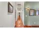 Hallway featuring hardwood floors, neutral paint, and decorative wall art at 3910 W Pebble Rd, Las Vegas, NV 89139