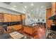 Open kitchen with wood cabinets, black countertops, and a large island with seating at 3910 W Pebble Rd, Las Vegas, NV 89139
