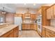 Open concept kitchen with wooden cabinets, tile backsplash and breakfast bar at 3910 W Pebble Rd, Las Vegas, NV 89139