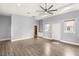 Open living room with wood floors, recessed lighting, and neutral paint with built-in shelving at 3910 W Pebble Rd, Las Vegas, NV 89139