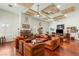 Inviting living room featuring hardwood floors, a stone fireplace and comfortable leather seating at 3910 W Pebble Rd, Las Vegas, NV 89139