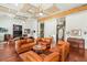 Spacious living room with hardwood floors, custom ceiling panels, and comfortable seating arrangement at 3910 W Pebble Rd, Las Vegas, NV 89139