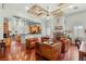 Spacious living area featuring hardwood floors, a stone fireplace and open access to the kitchen at 3910 W Pebble Rd, Las Vegas, NV 89139