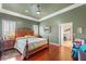 Spacious main bedroom with hardwood floors, crown molding, and a king-size bed at 3910 W Pebble Rd, Las Vegas, NV 89139