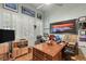 Functional home office with a large wood desk, ample storage, and natural light from shuttered windows at 3910 W Pebble Rd, Las Vegas, NV 89139