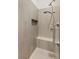 Modern shower with gray tile, a built-in bench, and a hand-held showerhead at 3910 W Pebble Rd, Las Vegas, NV 89139