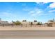 Street view of the house, showing landscaping and a fenced yard in a desert environment at 3910 W Pebble Rd, Las Vegas, NV 89139