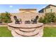 Inviting backyard with elevated patio area, chairs, and fire pit, perfect for outdoor gatherings at 4352 Browns Creek Ave, North Las Vegas, NV 89084