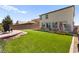 Expansive backyard featuring an artificial lawn, patio, garden boxes, and a charming seating area at 4352 Browns Creek Ave, North Las Vegas, NV 89084