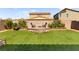 Spacious backyard featuring a fire pit with seating and lush green grass, perfect for outdoor entertaining at 4352 Browns Creek Ave, North Las Vegas, NV 89084