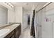 Bathroom featuring double sinks, granite counters, a glass shower, and a walk-in closet at 4352 Browns Creek Ave, North Las Vegas, NV 89084