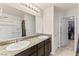 Bathroom features double sinks, a shower with curtains, and a walk-in closet at 4352 Browns Creek Ave, North Las Vegas, NV 89084